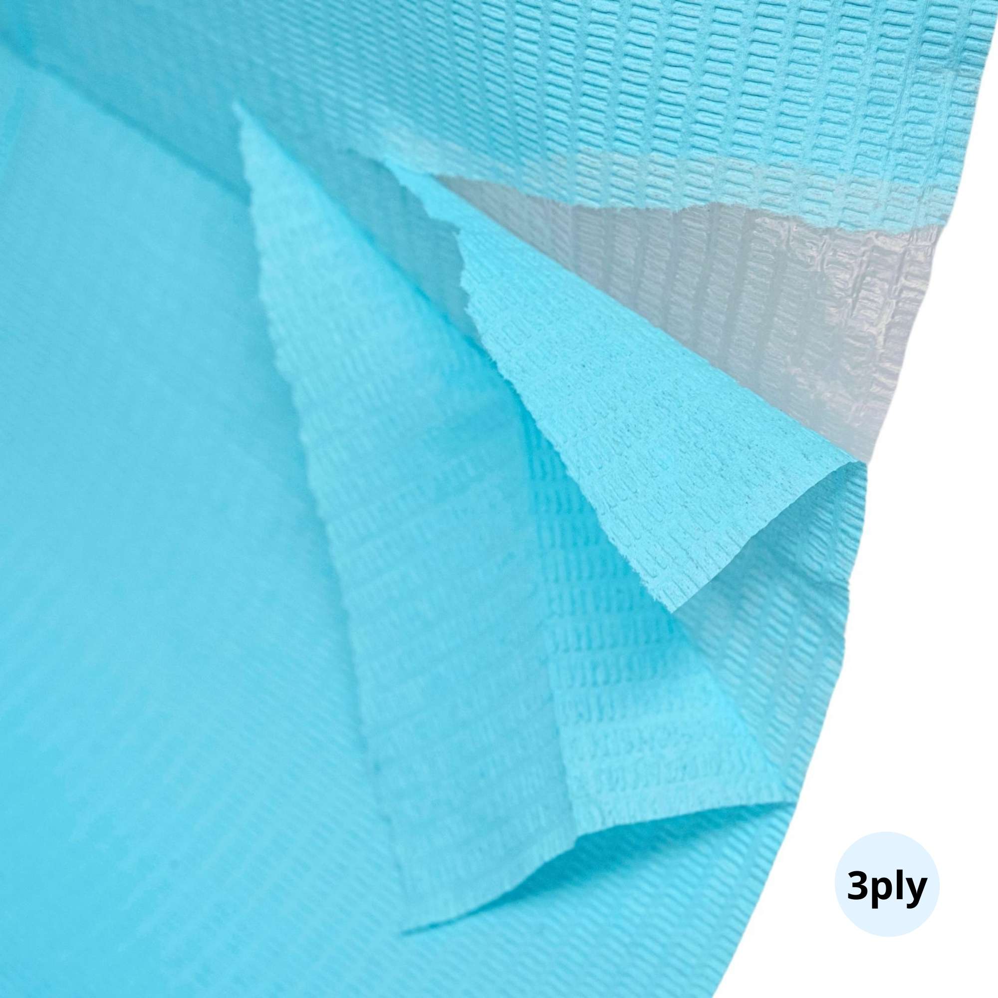 Close-up of blue dental bib showing 2 absorbent layers and 1 waterproof layer 3 layer in total