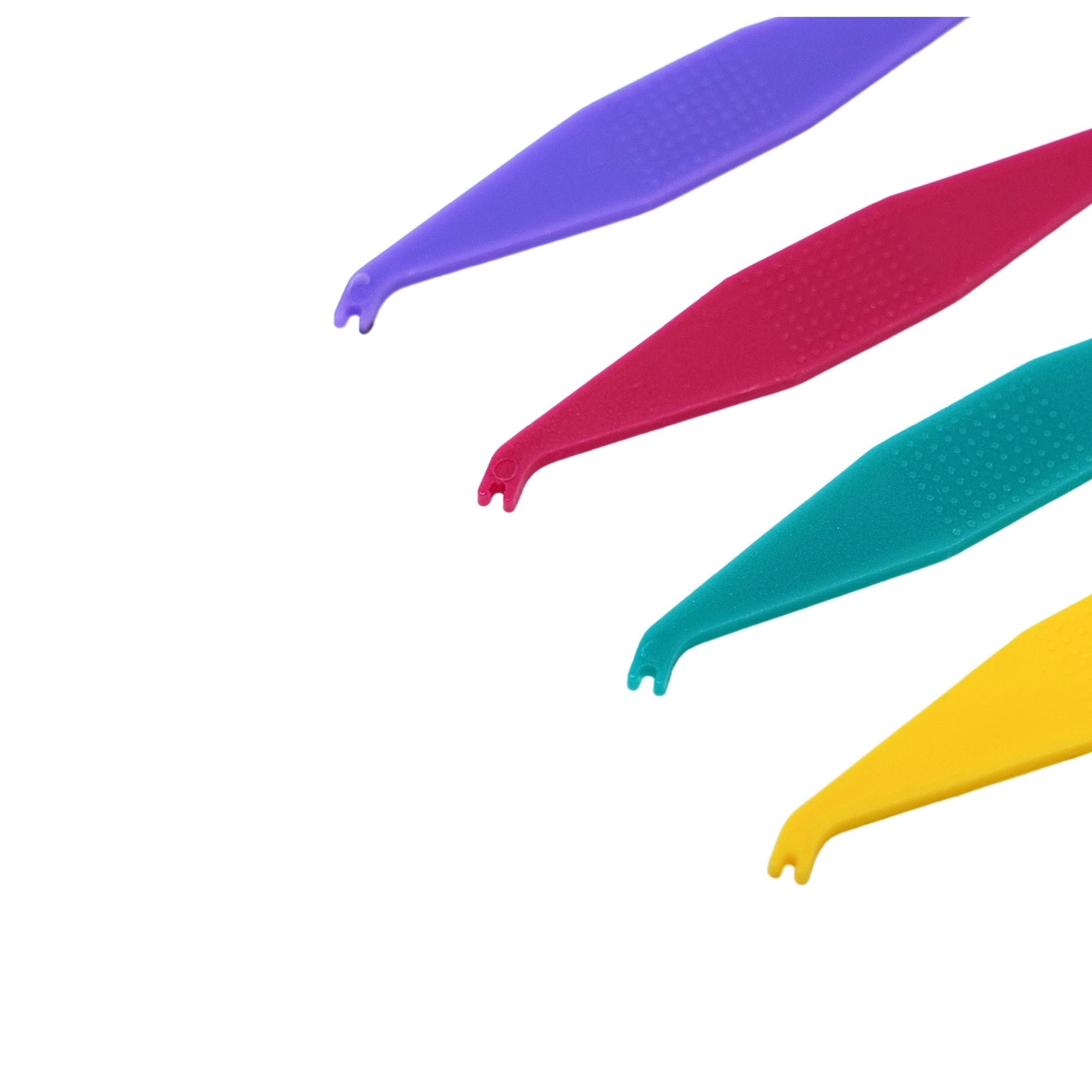 Orthodontic elastic placers with textured grip multi-colored placer end close up