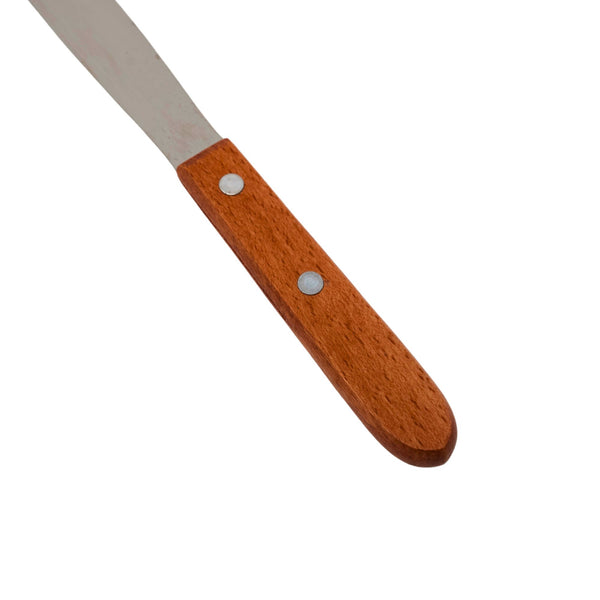 Close-up of wood handle on stainless steel spatula